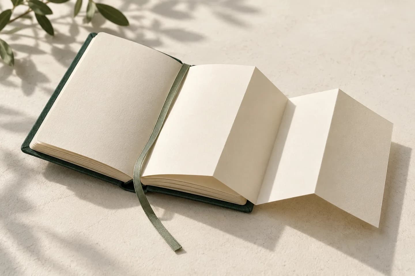 An open forest-green field notebook with ivory pages unfolding into paper steps.